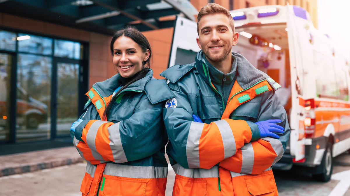 Frontliners standing together in front of an ambulance